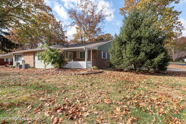 view of front of property featuring covered porch and central AC