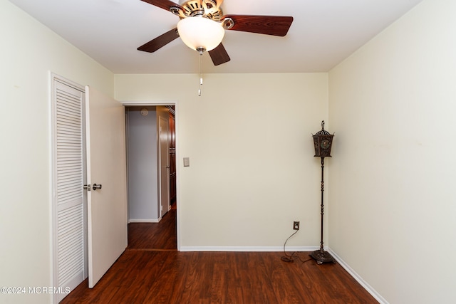 unfurnished bedroom featuring dark wood-type flooring and ceiling fan