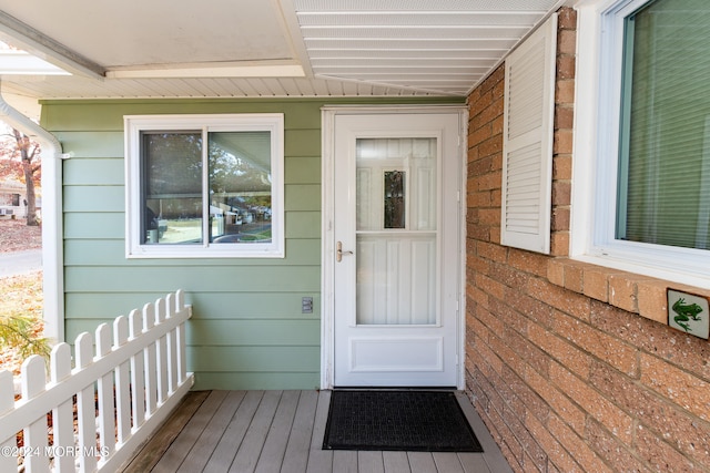 view of exterior entry featuring a deck