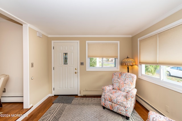 entryway featuring hardwood / wood-style floors, crown molding, and a baseboard heating unit