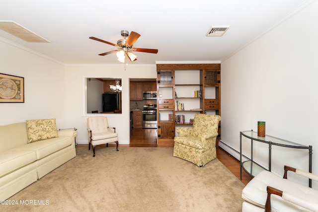 living room with ceiling fan with notable chandelier, carpet floors, and ornamental molding