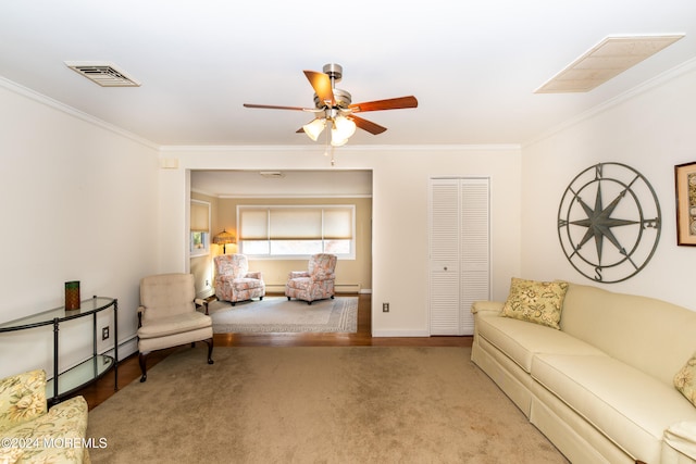 carpeted living room featuring ceiling fan, a baseboard heating unit, and crown molding