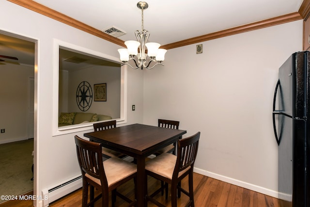 dining room with an inviting chandelier, wood-type flooring, ornamental molding, and a baseboard radiator