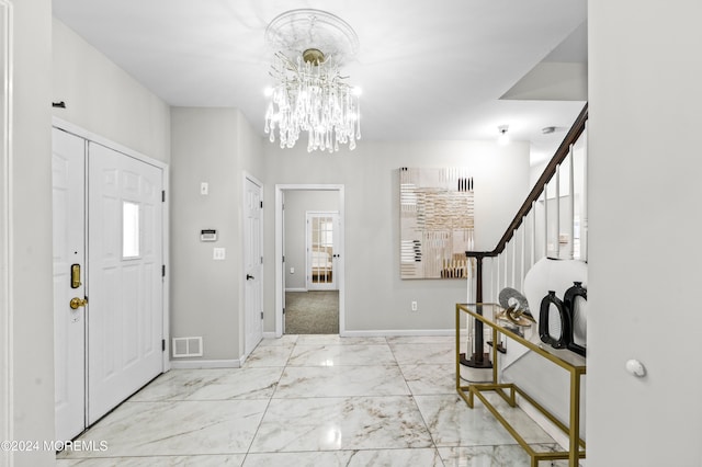 foyer entrance with a chandelier