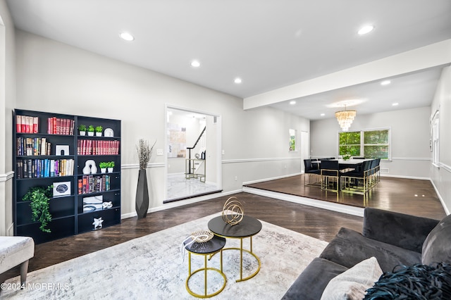 living room featuring an inviting chandelier and dark hardwood / wood-style floors