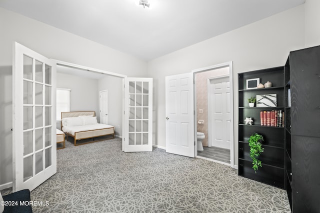 unfurnished bedroom featuring connected bathroom and french doors