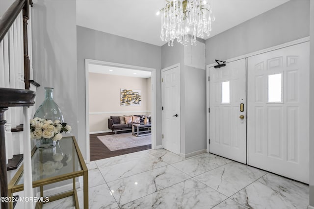 entryway featuring light wood-type flooring and an inviting chandelier