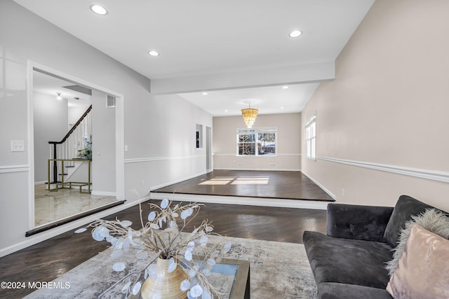 living room featuring wood-type flooring and beam ceiling