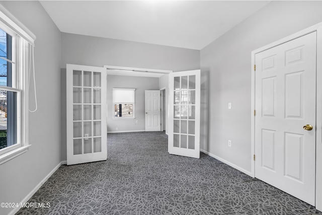 unfurnished room with a wealth of natural light and french doors