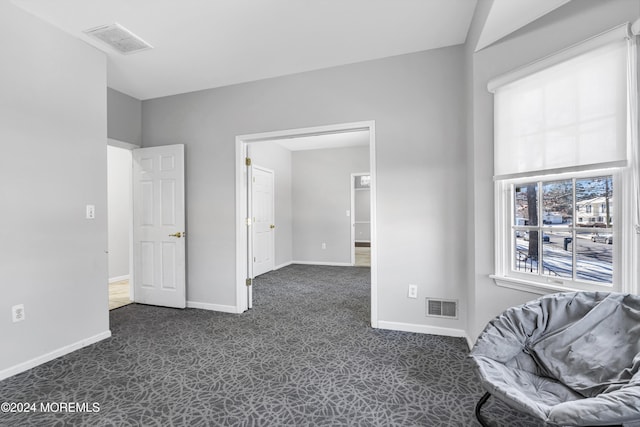 interior space featuring dark colored carpet