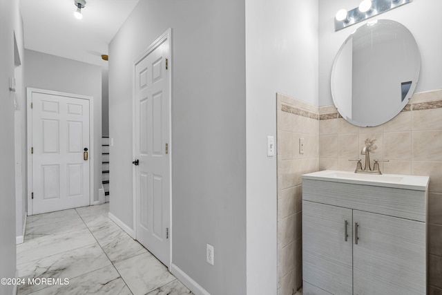 bathroom with tile walls and vanity