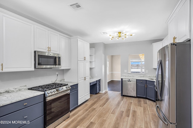 kitchen featuring light hardwood / wood-style floors, white cabinetry, and appliances with stainless steel finishes