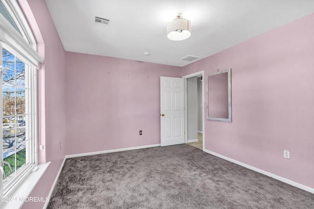 carpeted spare room with a wealth of natural light