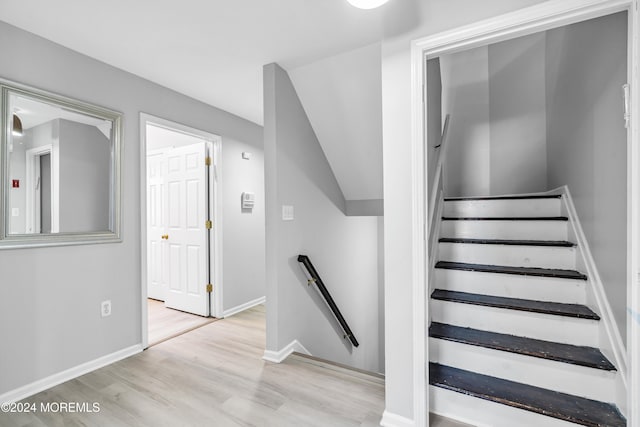 stairway with hardwood / wood-style flooring