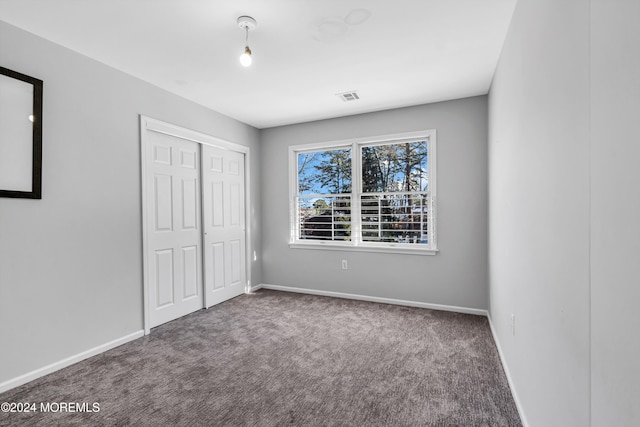 unfurnished bedroom with carpet floors and a closet