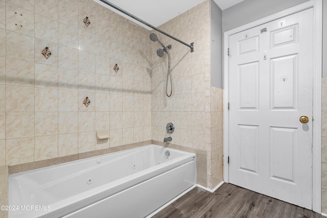 bathroom featuring tiled shower / bath combo and hardwood / wood-style flooring