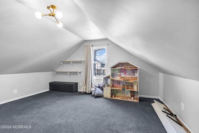 additional living space featuring dark colored carpet and vaulted ceiling