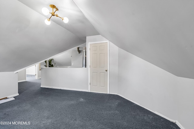 additional living space featuring vaulted ceiling and dark carpet