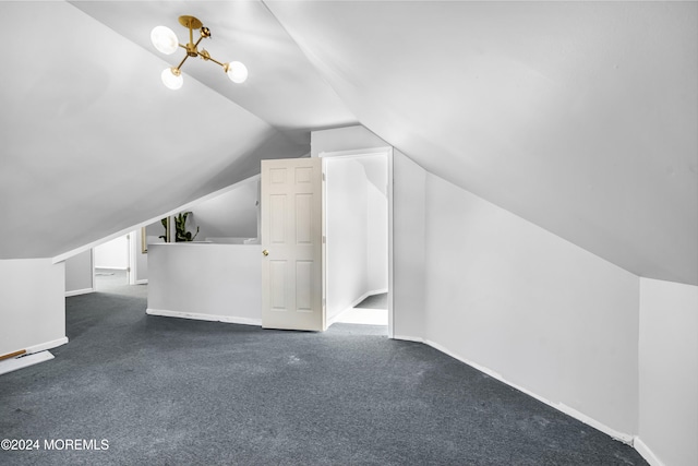 bonus room with vaulted ceiling and dark carpet