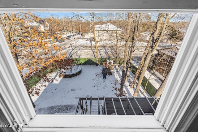 view of snow covered back of property