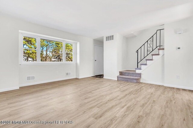 unfurnished living room featuring light wood-type flooring