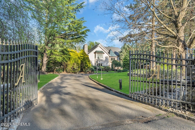 view of gate featuring a lawn