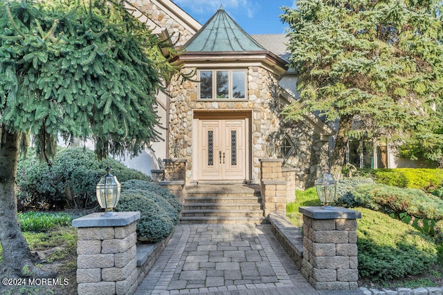 view of exterior entry featuring french doors