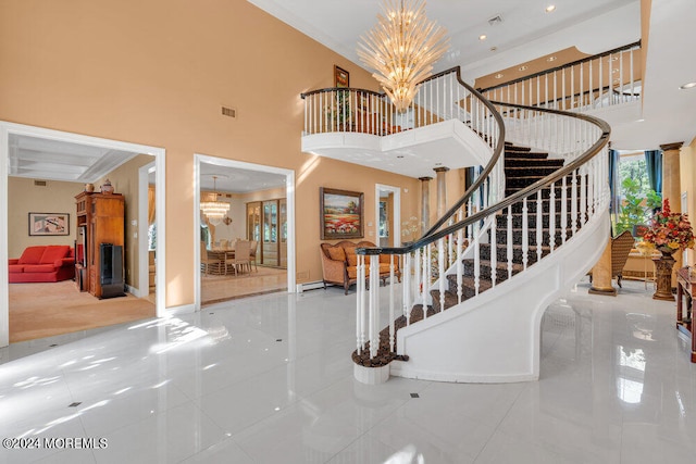 tiled foyer with a high ceiling and an inviting chandelier