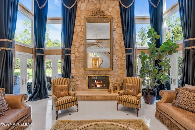 sitting room featuring french doors, tile patterned flooring, and a fireplace