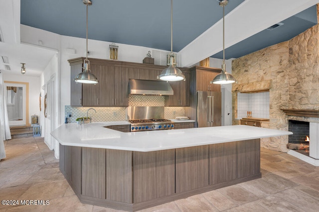 kitchen featuring hanging light fixtures, decorative backsplash, appliances with stainless steel finishes, and exhaust hood