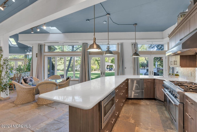 kitchen featuring french doors, appliances with stainless steel finishes, and a healthy amount of sunlight