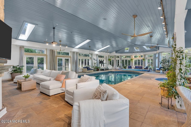 view of pool featuring ceiling fan and a skylight