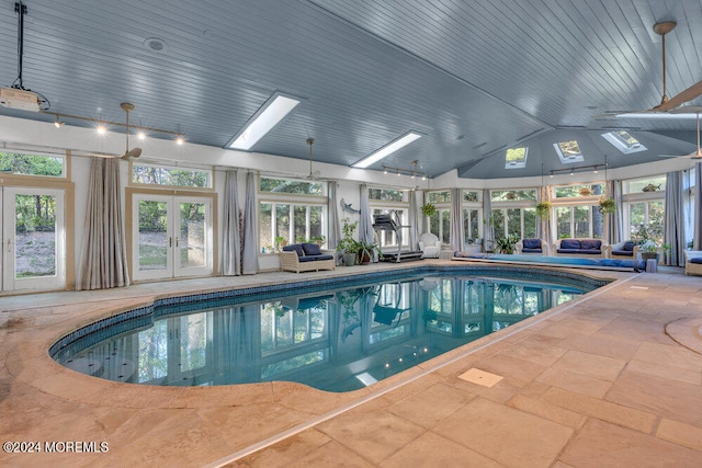 view of pool with a skylight and french doors