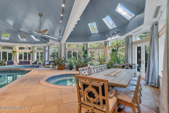 view of pool featuring french doors, an indoor hot tub, ceiling fan, and a skylight