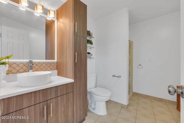 bathroom with tile patterned flooring, vanity, and toilet