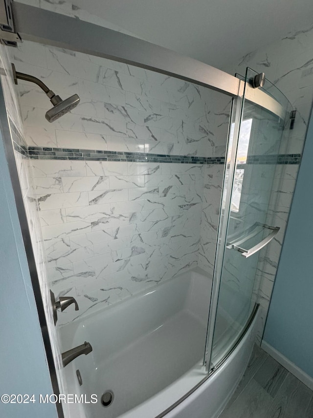 bathroom featuring shower / bath combination with glass door