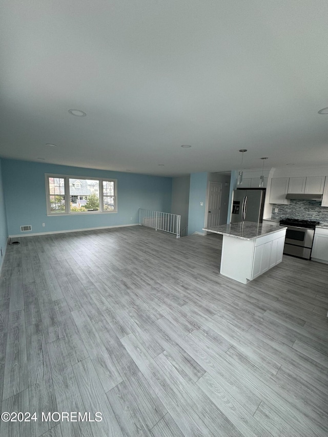 unfurnished living room with light hardwood / wood-style floors