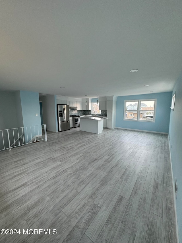 unfurnished living room with light wood-type flooring