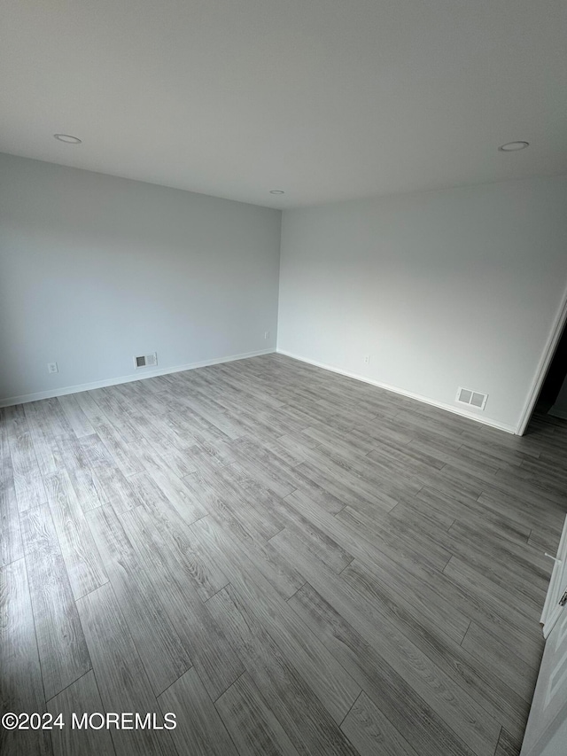 empty room with hardwood / wood-style floors