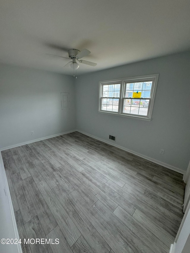 empty room featuring ceiling fan and light hardwood / wood-style flooring