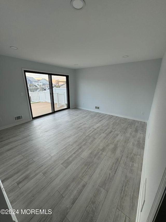 unfurnished room with light hardwood / wood-style flooring