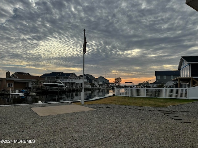 yard at dusk featuring a boat dock