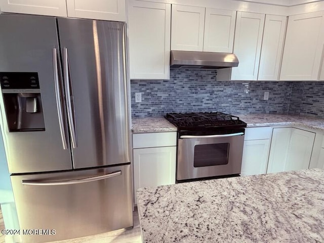 kitchen featuring white cabinetry, stainless steel appliances, and light stone counters