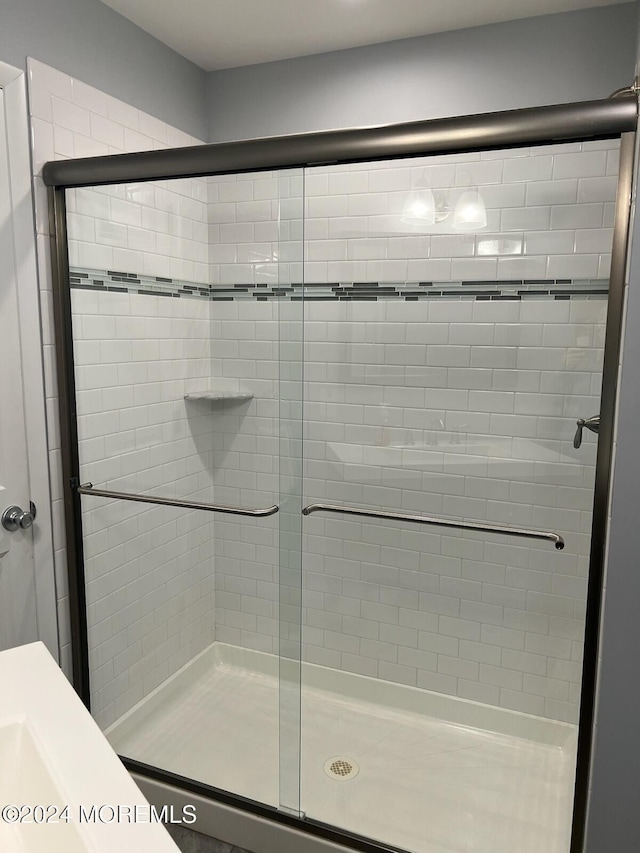 bathroom featuring a shower with shower door