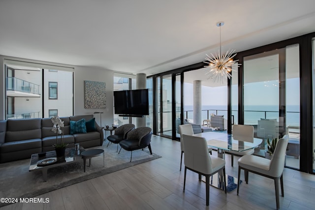 dining area featuring hardwood / wood-style floors, expansive windows, and a chandelier