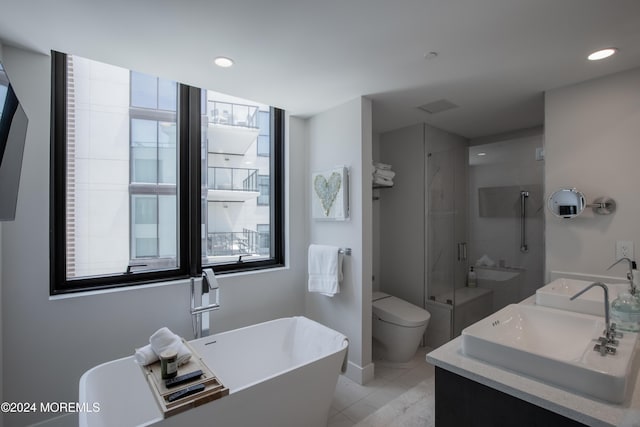 full bathroom with shower with separate bathtub, vanity, toilet, and tile patterned floors