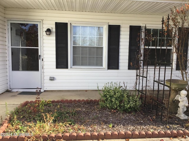 view of exterior entry featuring a porch