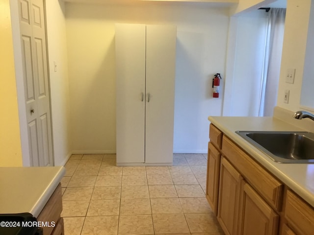 kitchen with light tile patterned flooring and sink