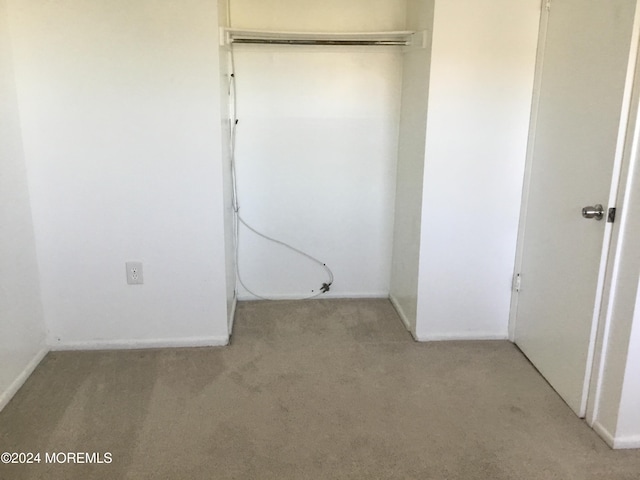 clothes washing area with light colored carpet