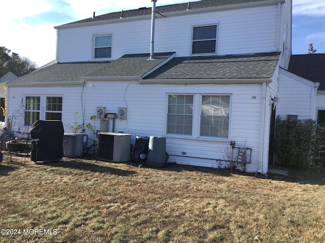 back of property featuring a yard and central AC unit